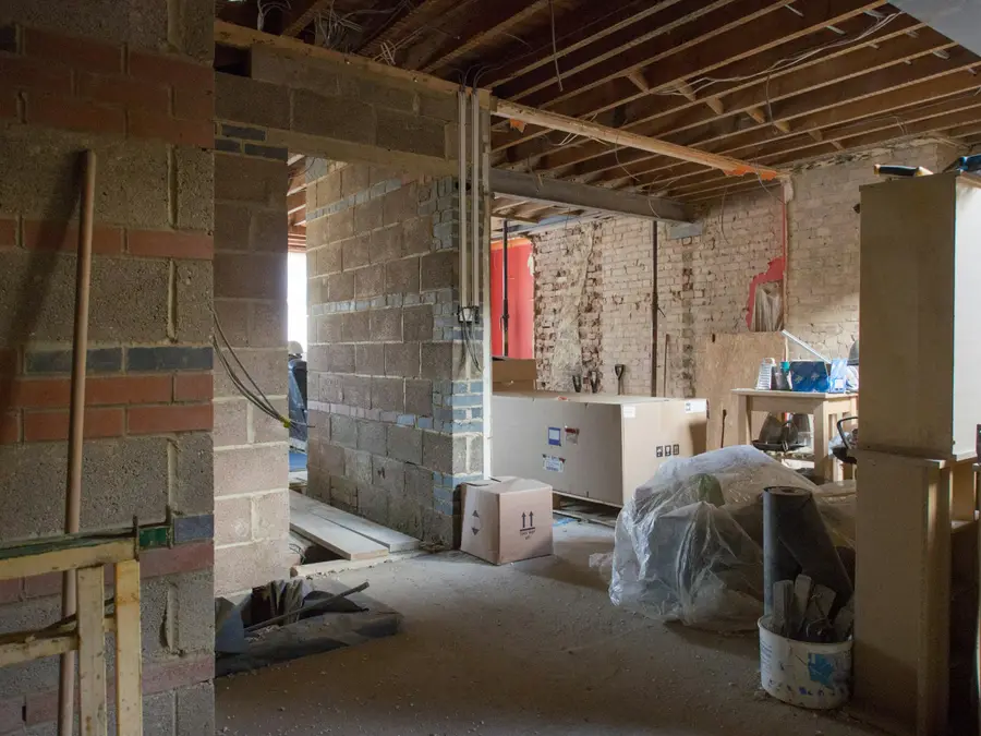 Basement being rebuilt with concrete block walls, timber joists and open framing