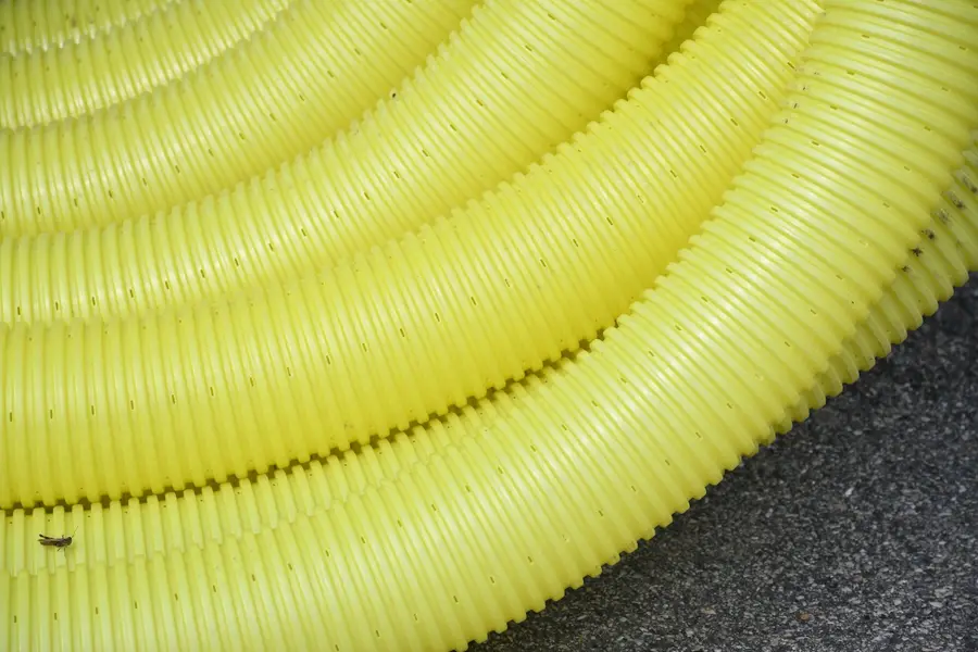 Coils of yellow corrugated drainage pipe