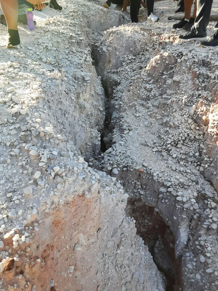 Trench cut through stony, gravelly ground